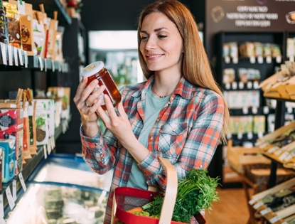Woman looking at honey on the shelf